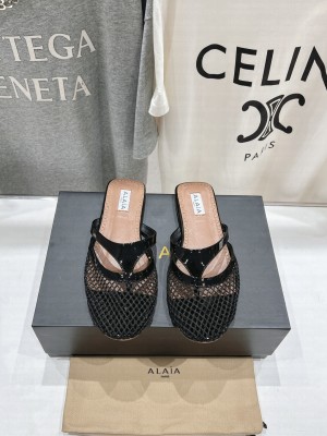 Alaïa INFRADITO FLAT MULES IN FISHNET AND LEATHER BLACK